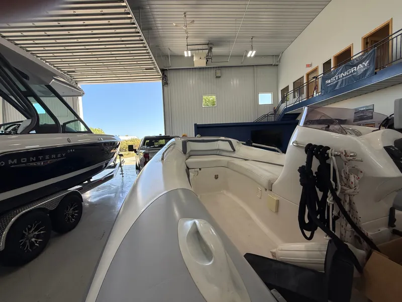 Slide: The Image of 2009 Walker Bay Generation 430 boat in a storage facility, alongside a Monterey boat. - 6