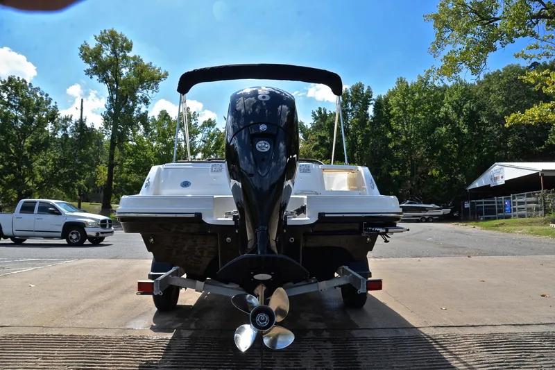 Slide: The Image of 2018 Bayliner VR5 Bowrider OB with outboard motor on trailer, parked outdoors. - 13