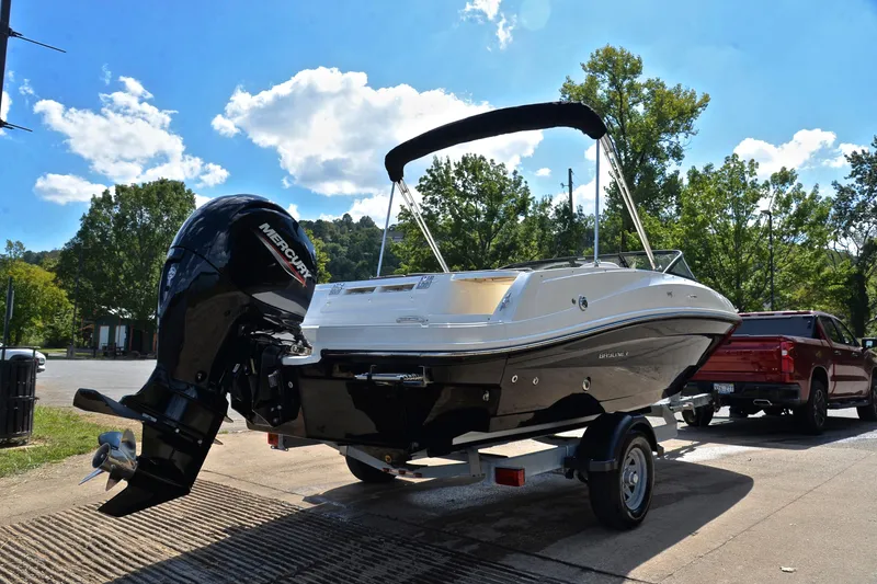 Slide: The Image of 2018 Bayliner VR5 Bowrider OB on trailer, parked outdoors under a clear blue sky. - 14