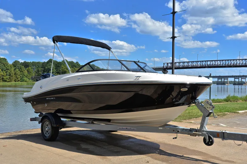 Slide: The Image of 2018 Bayliner VR5 Bowrider OB on trailer by scenic waterfront with blue sky. - 16