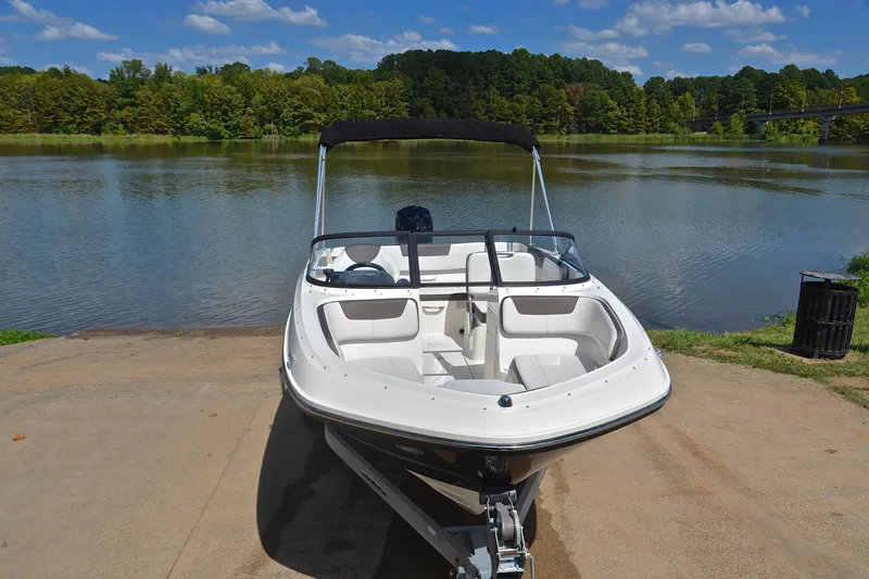 Slide: The Image of 2018 Bayliner VR5 Bowrider OB on a boat ramp by a scenic lake. - 17