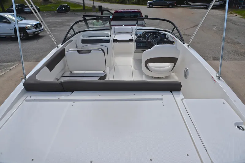Slide: The Image of 2018 Bayliner VR5 Bowrider OB interior with seating and steering wheel, parked on a trailer. - 18