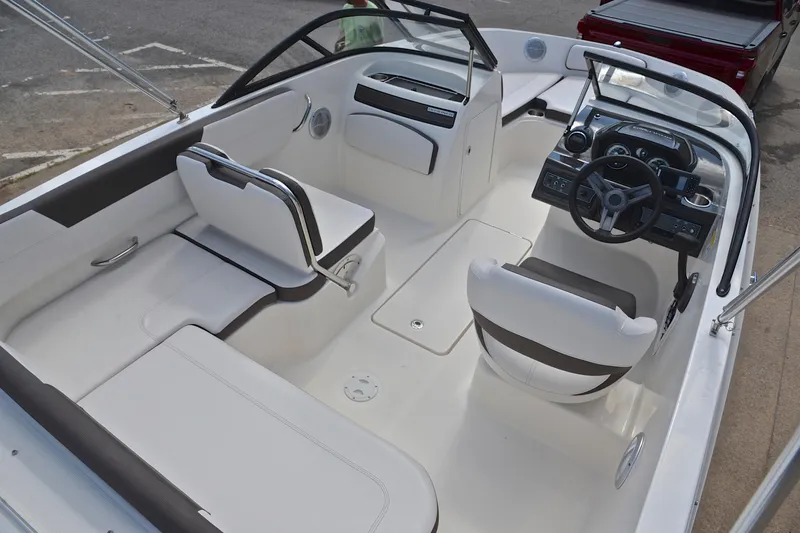 Slide: The Image of 2018 Bayliner VR5 Bowrider OB interior with white seating and modern dashboard. - 19