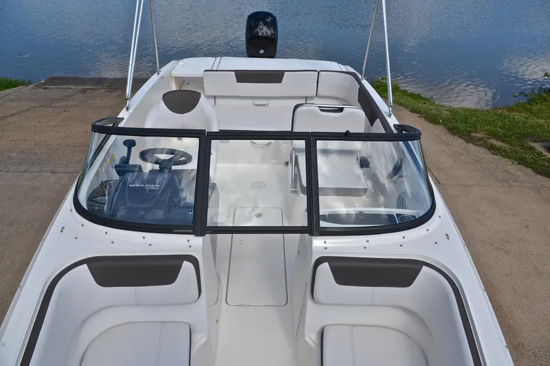 Slide: The Image of 2018 Bayliner VR5 Bowrider OB boat with spacious seating and sleek design by the water. - 20