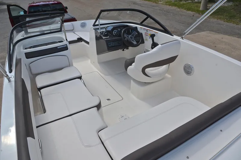 Slide: The Image of 2018 Bayliner VR5 Bowrider OB interior with white seating and steering console. - 23