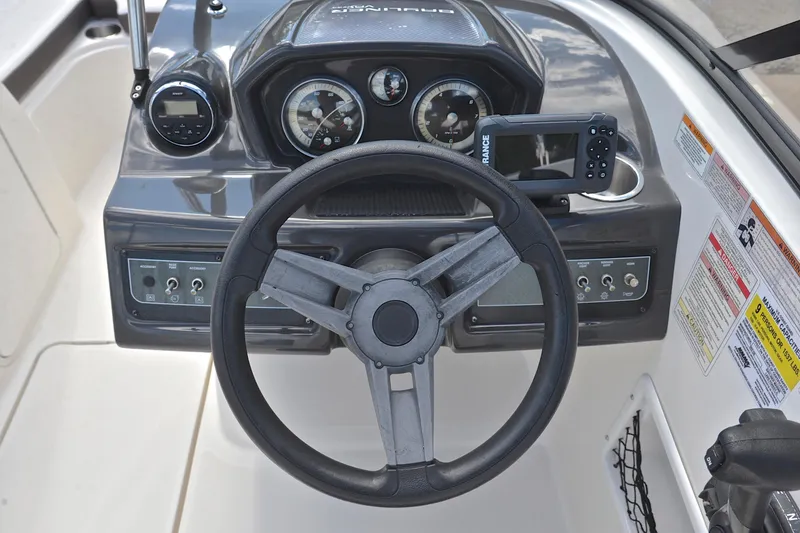 Slide: The Image of 2018 Bayliner VR5 Bowrider OB dashboard with steering wheel and control panel. - 24