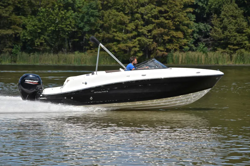 Slide: The Image of 2018 Bayliner VR5 Bowrider OB cruising on a calm lake with lush greenery. - 3
