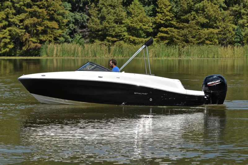 Slide: The Image of 2018 Bayliner VR5 Bowrider OB on calm lake with lush green background. - 9