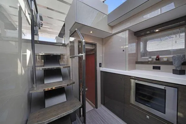 Slide: The Image of Modern interior of 2018 Cruisers Cantius yacht with sleek kitchen and staircase. - 11