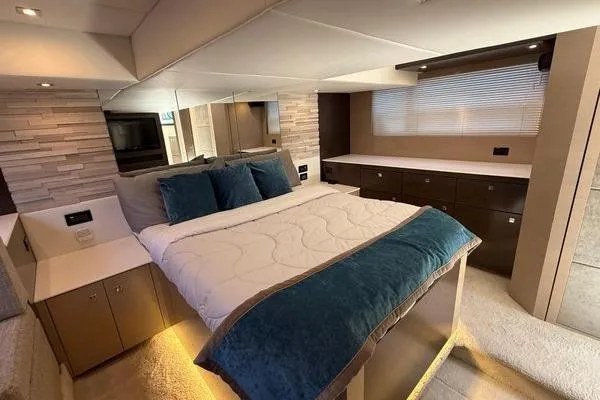 Slide: The Image of Luxurious 2018 Cruisers Cantius yacht bedroom with modern decor and ambient lighting. - 14