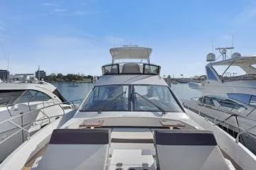 Slide: The Image of 2018 Cruisers Cantius yacht docked at marina, surrounded by other boats. - 2