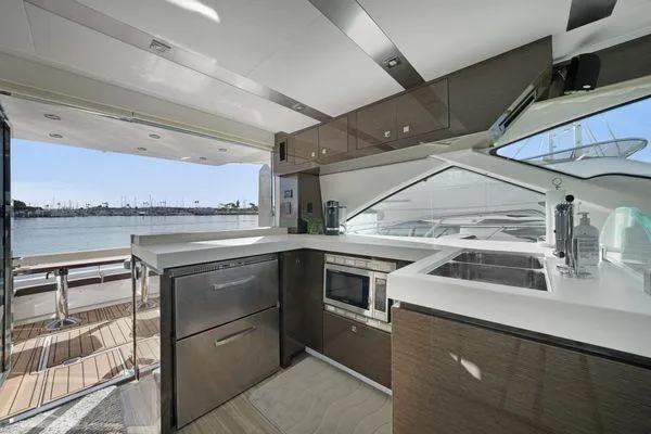 Slide: The Image of Modern kitchen interior on 2018 Cruisers Cantius yacht with sleek cabinetry and ocean view. - 5