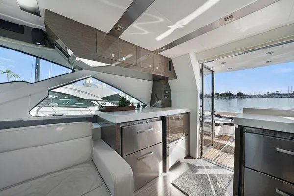 Slide: The Image of Luxurious interior of a 2018 Cruisers Cantius yacht with modern kitchen and waterfront view. - 6