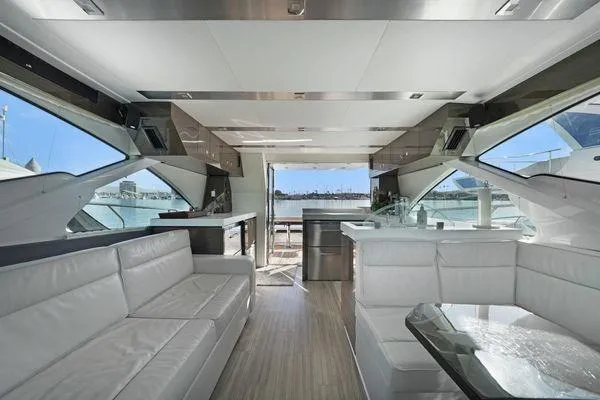 Slide: The Image of Luxurious interior of a 2018 Cruisers Cantius yacht with modern seating and panoramic windows. - 7