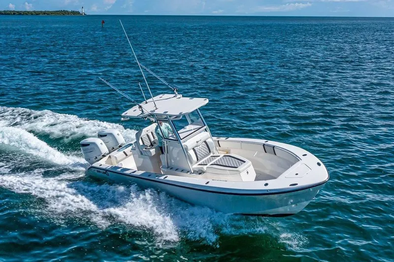 The Image of 2021 Sea-Lion 27 CC boat cruising on open water, showcasing sleek design and twin engines. - 0