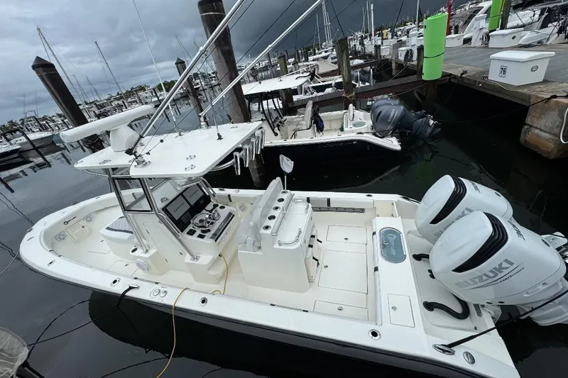 Slide: The Image of 2021 Sea-Lion 27 CC boat docked, featuring dual Suzuki outboard engines. - 3