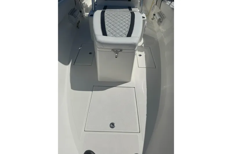 Slide: The Image of 2021 Sea-Lion 27 CC boat with Garmin equipment, docked under a clear blue sky. - 6