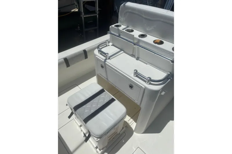 Slide: The Image of 2021 Sea-Lion 27 CC boat interior with cushioned seating and storage compartments. - 7