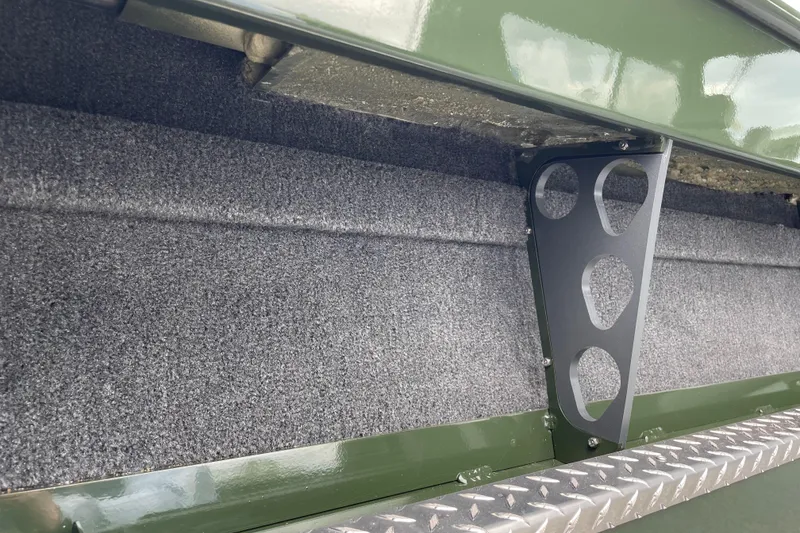 Slide: The Image of Interior detail of 2026 Hewescraft 210 Sea Runner ET HT boat, featuring carpeted surface and metal bracket. - 10