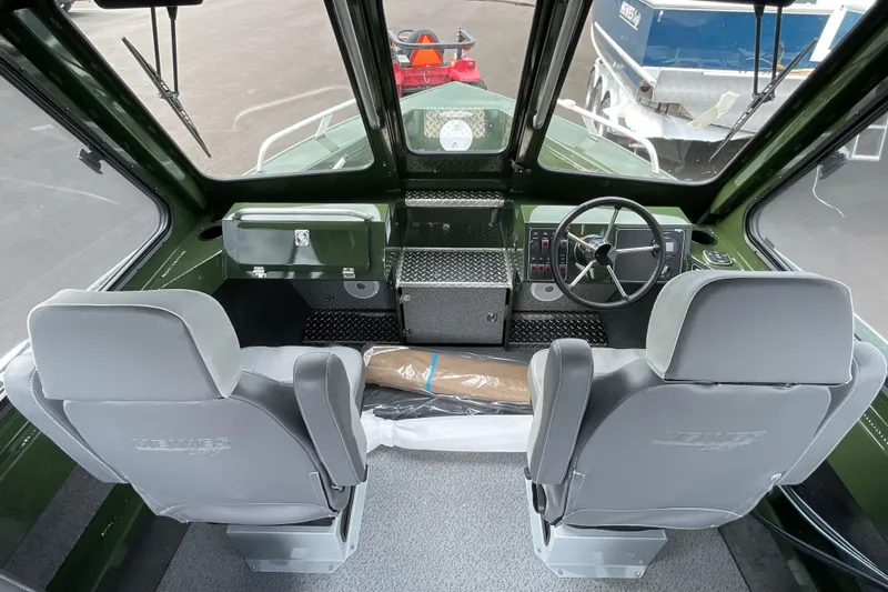 Slide: The Image of 2026 Hewescraft 210 Sea Runner ET HT interior with foldable seat and storage compartment. - 15