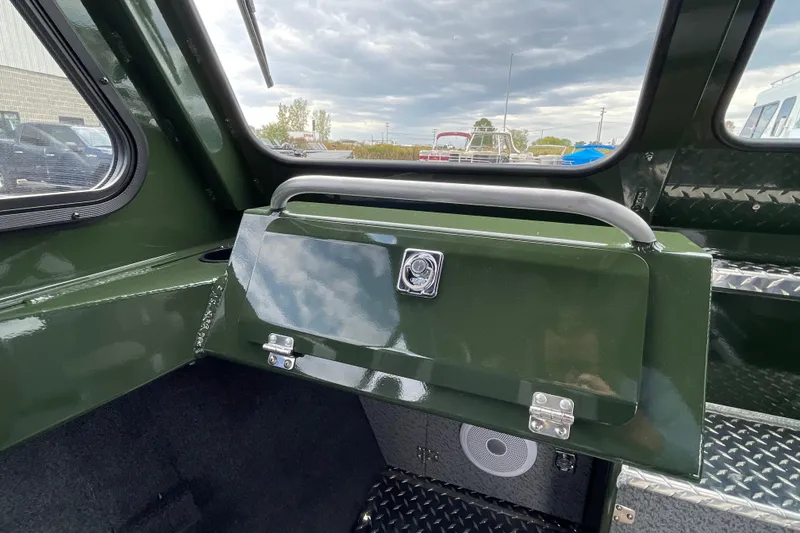 Slide: The Image of Interior of 2026 Hewescraft 210 Sea Runner ET HT boat, featuring steering wheel and seats. - 16