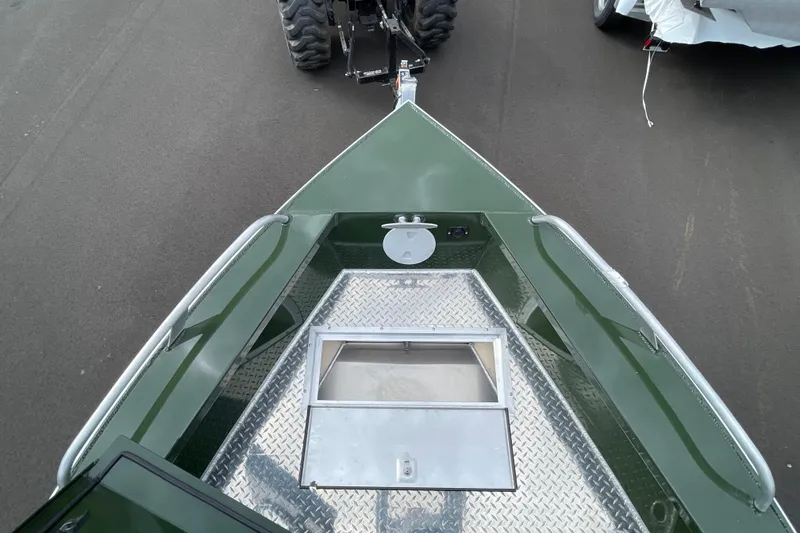 Slide: The Image of 2026 Hewescraft 210 Sea Runner ET HT boat with diamond plate flooring and green exterior. - 20