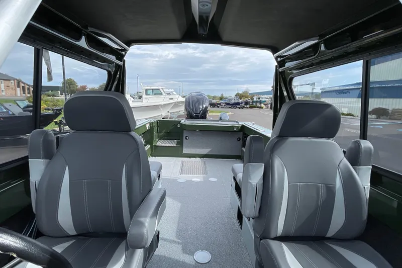 Slide: The Image of 2026 Hewescraft 210 Sea Runner ET HT boat, green exterior, front view with windshield wipers. - 22