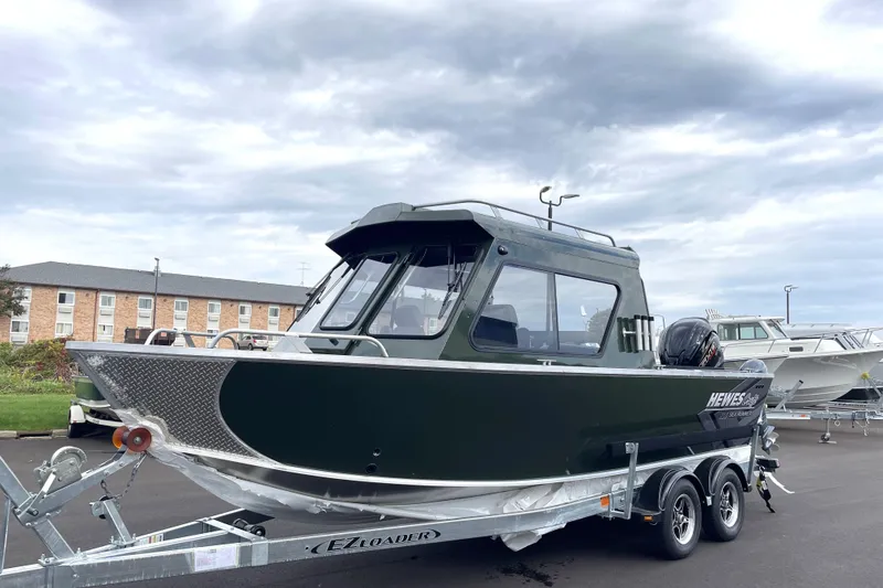 Slide: The Image of 2026 Hewescraft 210 Sea Runner ET HT boat on trailer, parked outdoors. - 32