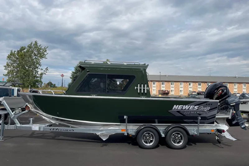 Slide: The Image of 2026 Hewescraft 210 Sea Runner ET HT boat on trailer, parked outdoors. - 33