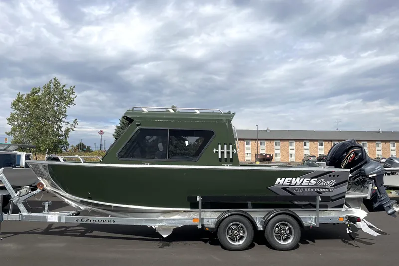 Slide: The Image of 2026 Hewescraft 210 Sea Runner ET HT boat on trailer, parked outdoors. - 34