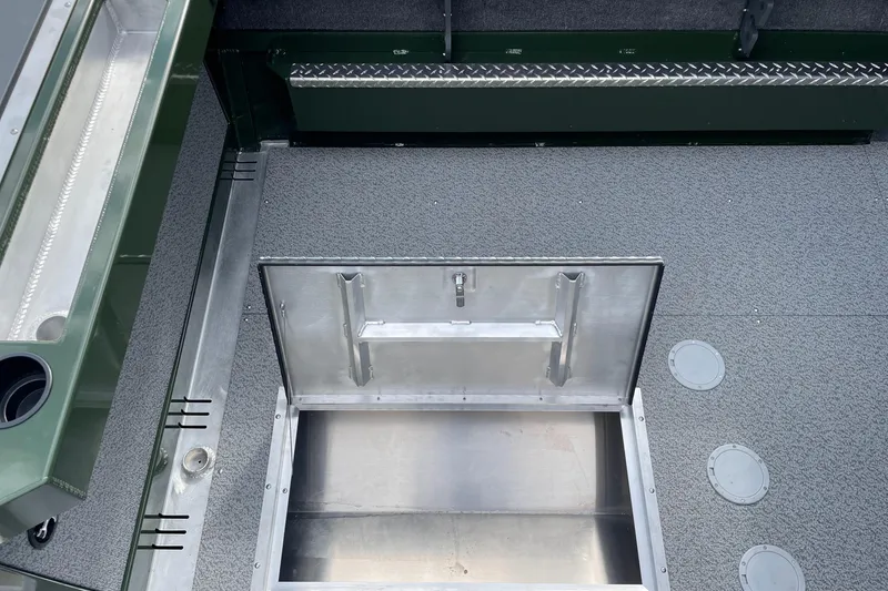 Slide: The Image of 2026 Hewescraft 210 Sea Runner ET HT boat with open storage compartment on deck. - 8