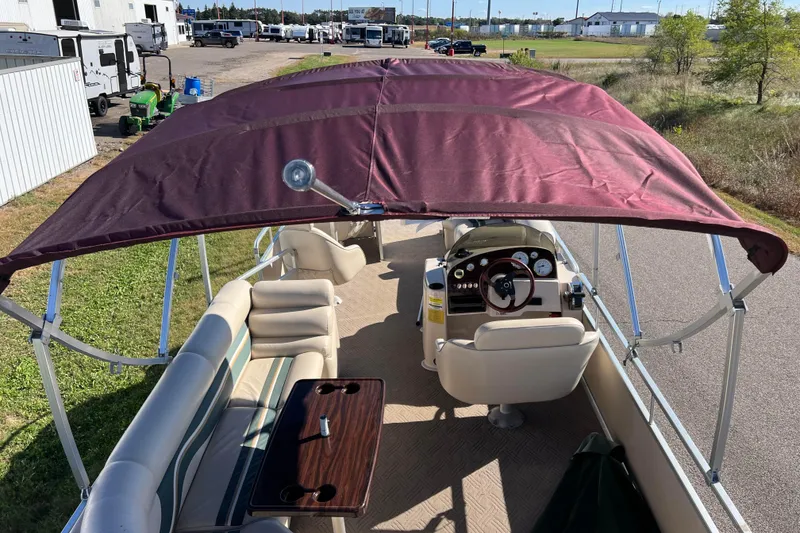 Slide: The Image of 2002 Premier 225 Majestic pontoon boat with maroon canopy and beige seating. - 10