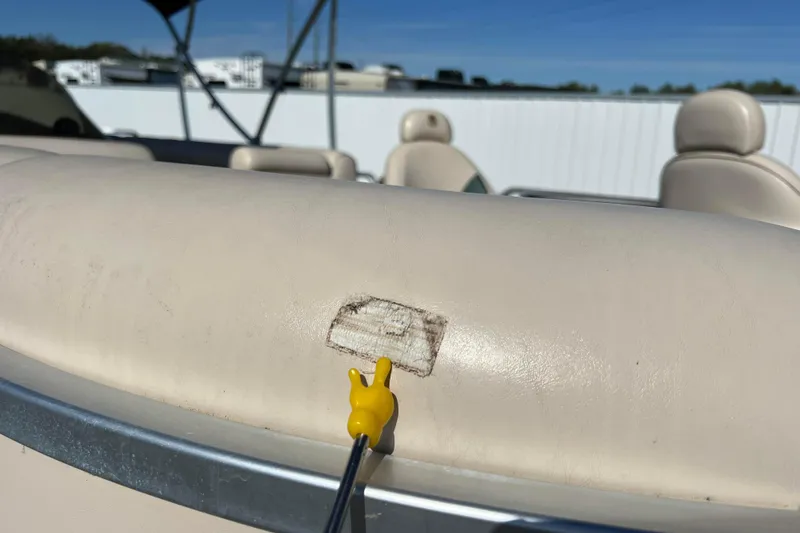 Slide: The Image of 2002 Premier 225 Majestic boat seat with minor damage, outdoor setting. - 15