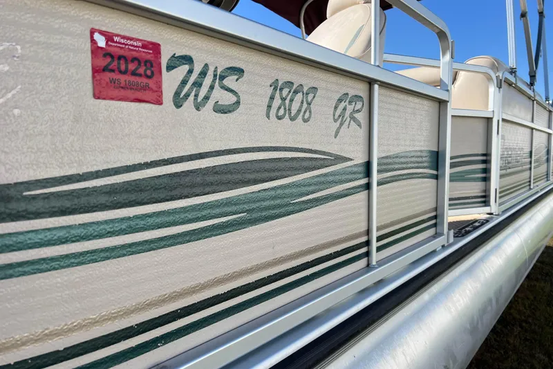 Slide: The Image of 2002 Premier 225 Majestic pontoon boat with Wisconsin registration sticker, side view. - 17