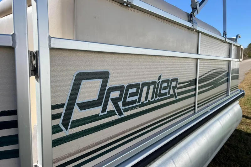 Slide: The Image of 2002 Premier 225 Majestic pontoon boat with logo and striped design. - 18