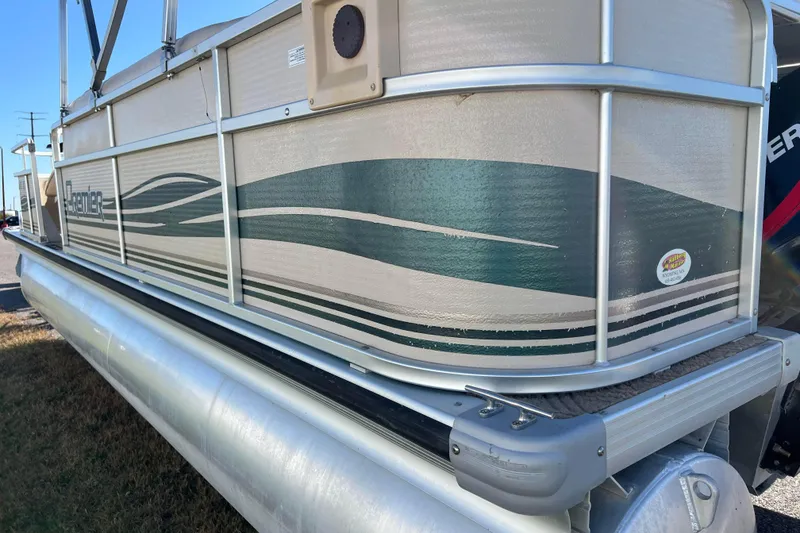 Slide: The Image of 2002 Premier 225 Majestic pontoon boat with green and beige design, side view. - 19