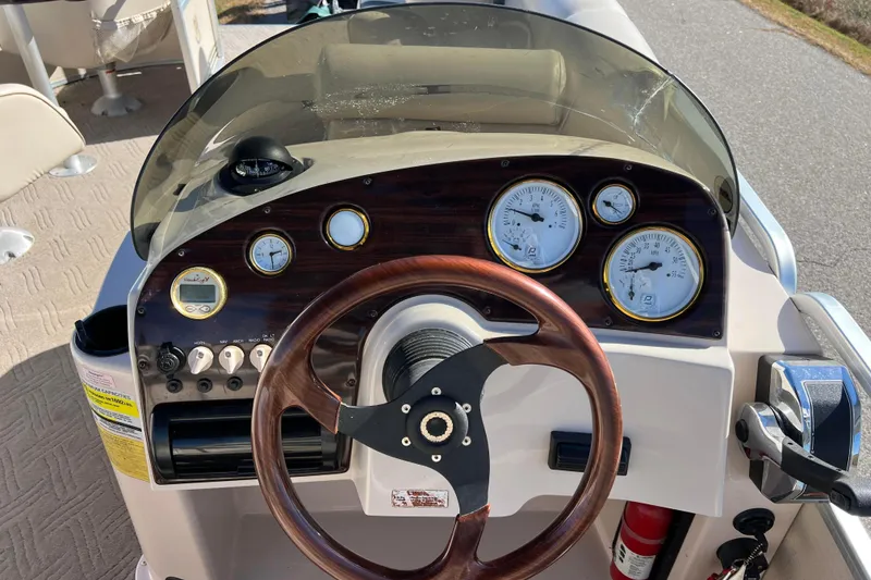 Slide: The Image of Steering console of 2002 Premier 225 Majestic boat with gauges and wooden wheel. - 20
