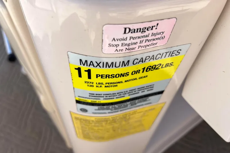 Slide: The Image of 2002 Premier 225 Majestic capacity label, max 11 persons or 1692 lbs, 120 HP motor. - 22
