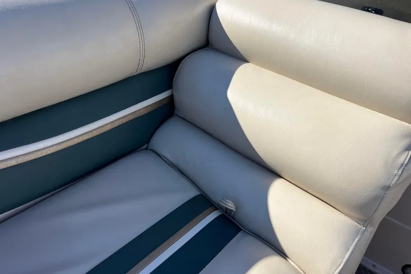 Slide: The Image of Premier 225 Majestic 2002 boat seat with beige and teal upholstery. - 29