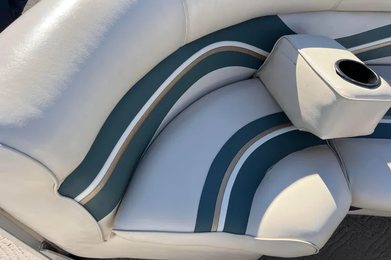 Slide: The Image of 2002 Premier 225 Majestic boat seat with blue and white upholstery and cup holder. - 30