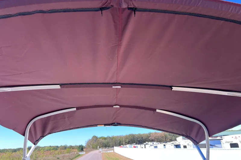 Slide: The Image of Burgundy canopy of 2002 Premier 225 Majestic boat, with metal support frame. - 35