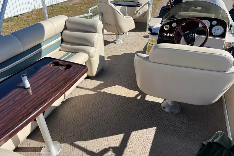 Slide: The Image of Interior of 2002 Premier 225 Majestic boat with beige seating and wooden table. - 37