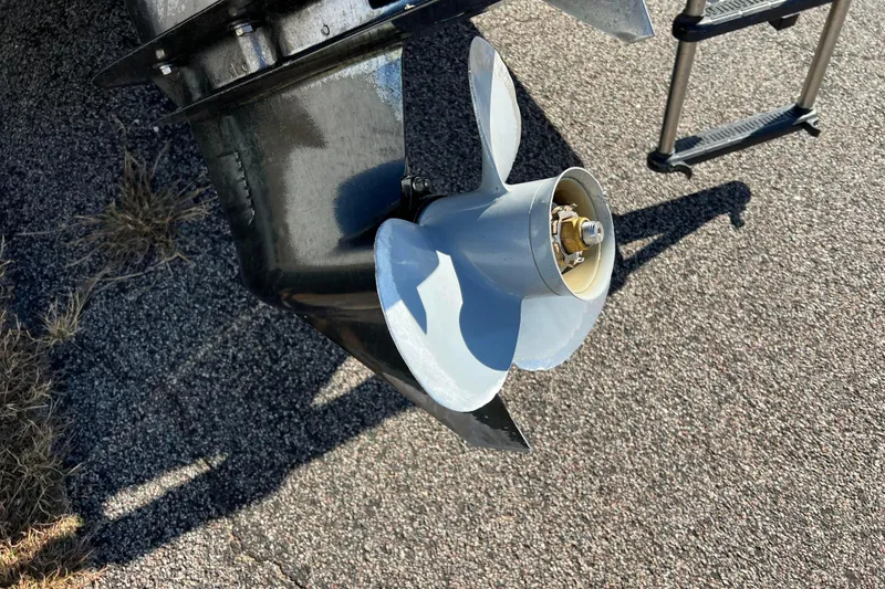 Slide: The Image of Propeller of a 2002 Premier 225 Majestic boat on pavement background. - 4