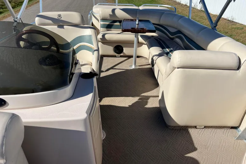 Slide: The Image of Interior of 2002 Premier 225 Majestic boat with beige seating and steering wheel. - 40