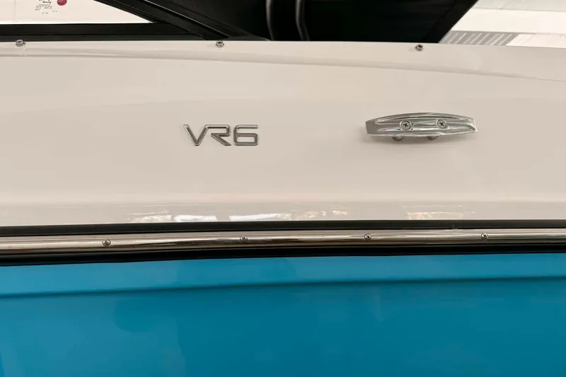 Slide: The Image of 2026 Bayliner VR6 Bowrider OB, white and blue exterior with chrome details. - 14