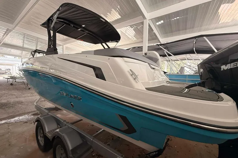 Slide: The Image of 2026 Bayliner VR6 Bowrider OB in showroom, featuring sleek design and vibrant blue hull. - 7
