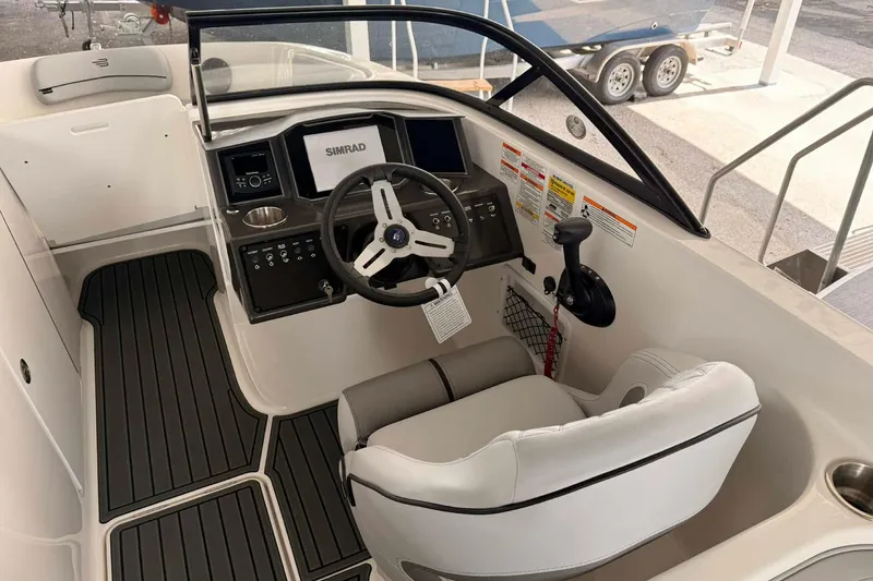 Slide: The Image of 2026 Bayliner VR6 Bowrider OB cockpit with steering wheel and control panel. - 9