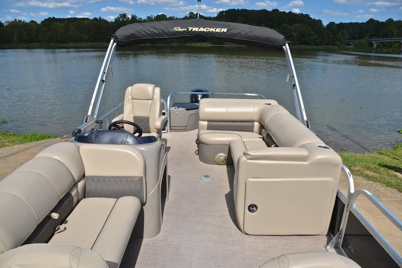Slide: The Image of 2023 Sun Tracker Fishin' Barge 20 DLX pontoon boat on a serene lake. - 20