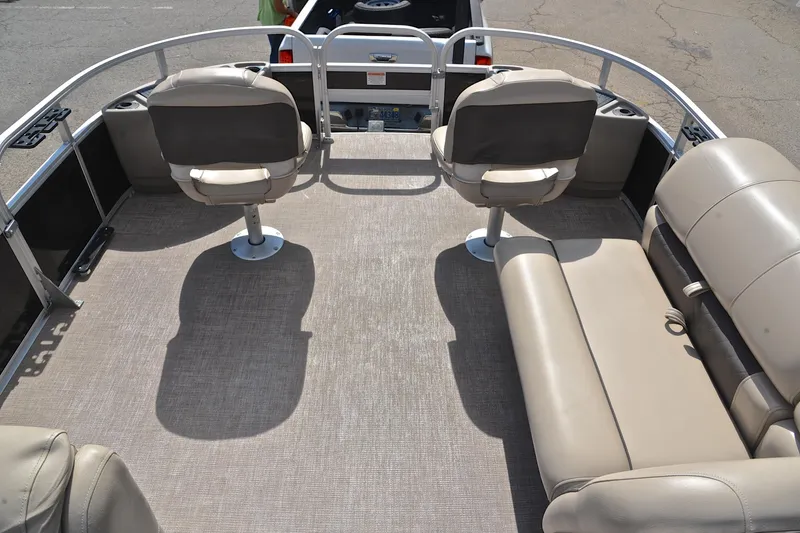 Slide: The Image of 2023 Sun Tracker Fishin' Barge 20 DLX interior with seating and fishing setup. - 21