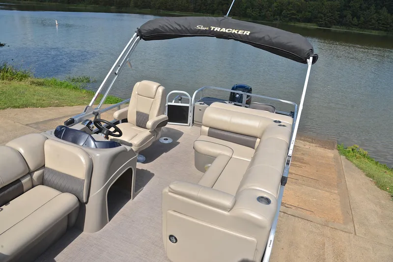 Slide: The Image of 2023 Sun Tracker Fishin' Barge 20 DLX pontoon boat by a serene lake. - 22